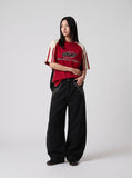 DAXUEN black oversized balloon pants with silver studs — model photo