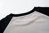 DAXUEN beige waffle knit long sleeve top with black collage graphics