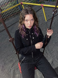 DAXUEN black cropped jacket with buckled straps — model photo