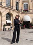 DAXUEN black cropped jacket with buckled straps — model photo