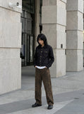 DAXUEN black denim jacket with gold detailing — model photo