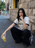 DAXUEN White ringer T-shirt with bold text and graphic — model photo