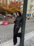 DAXUEN black faux leather motorcycle jacket with snap details — model photo