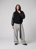 DAXUEN black oversized bomber jacket with faux leather sleeves — model photo