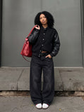 DAXUEN black oversized bomber jacket with faux leather sleeves — model photo