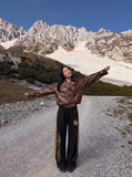 DAXUEN black wide-leg track pants with embroidered crest — model photo