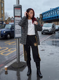 DAXUEN black wide-leg track pants with embroidered crest — model photo