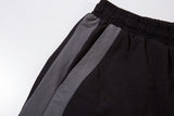 DAXUEN black wide-leg track pants with dark grey curved panels