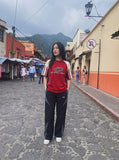 DAXUEN black wide-leg track pants with dark grey curved panels — model photo