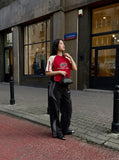 DAXUEN black wide-leg track pants with dark grey curved panels — model photo