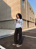 DAXUEN light blue long-sleeve t-shirt with blocky '06' graphic — model photo