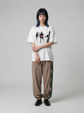 DAXUEN dark purple oversized blurred-figures graphic tee — model photo