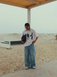 DAXUEN dark purple oversized blurred-figures graphic tee — model photo