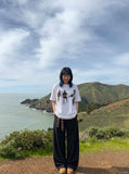 DAXUEN dark purple oversized blurred-figures graphic tee — model photo