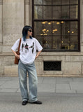DAXUEN dark purple oversized blurred-figures graphic tee — model photo