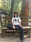 DAXUEN dark purple oversized blurred-figures graphic tee — model photo
