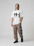 DAXUEN dark purple oversized blurred-figures graphic tee — model photo