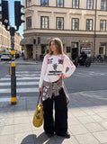 DAXUEN white long-sleeve jersey with bold brushstroke graphics — model photo
