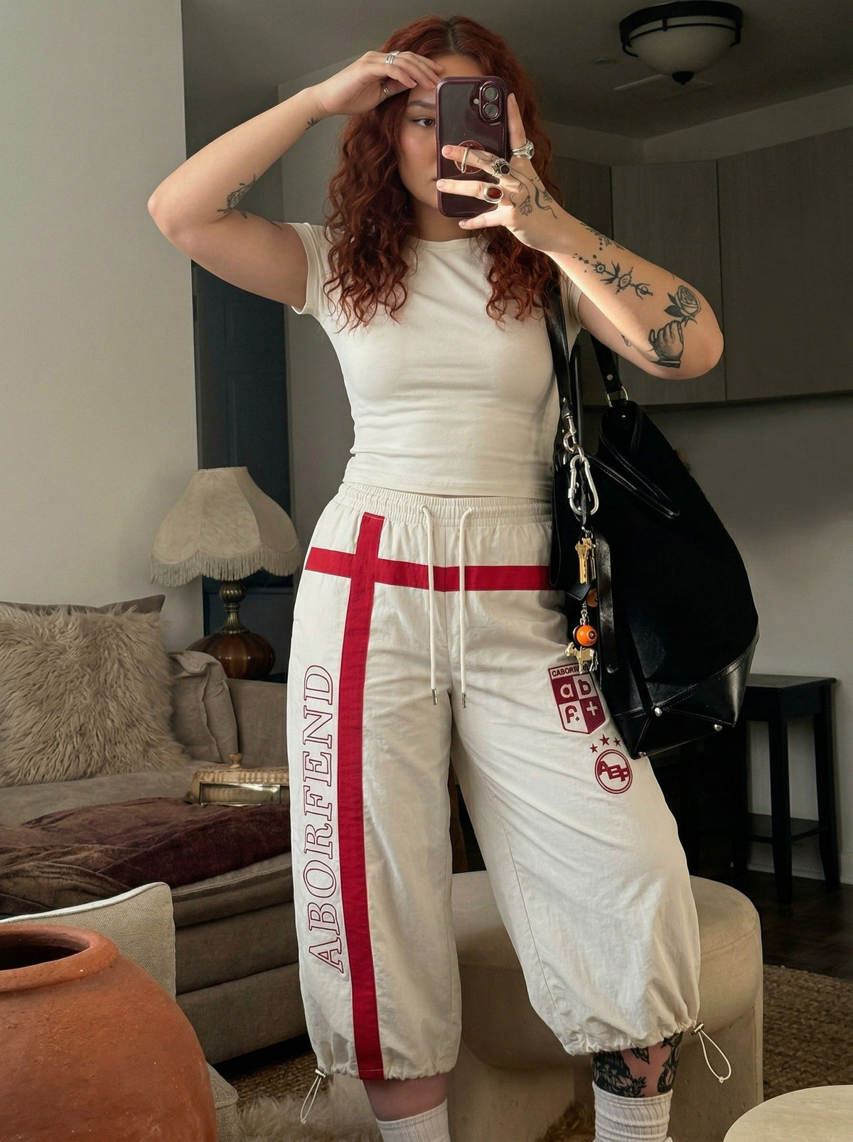 DAXUEN Wide-leg pants with red cross graphic and adjustable drawstrings — model photo