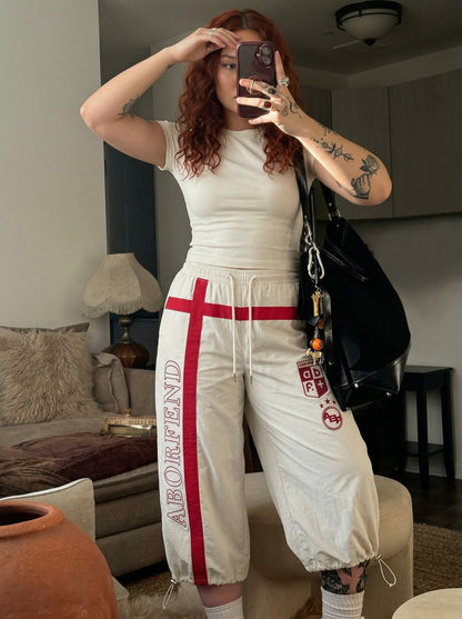 DAXUEN Wide-leg pants with red cross graphic and adjustable drawstrings — model photo