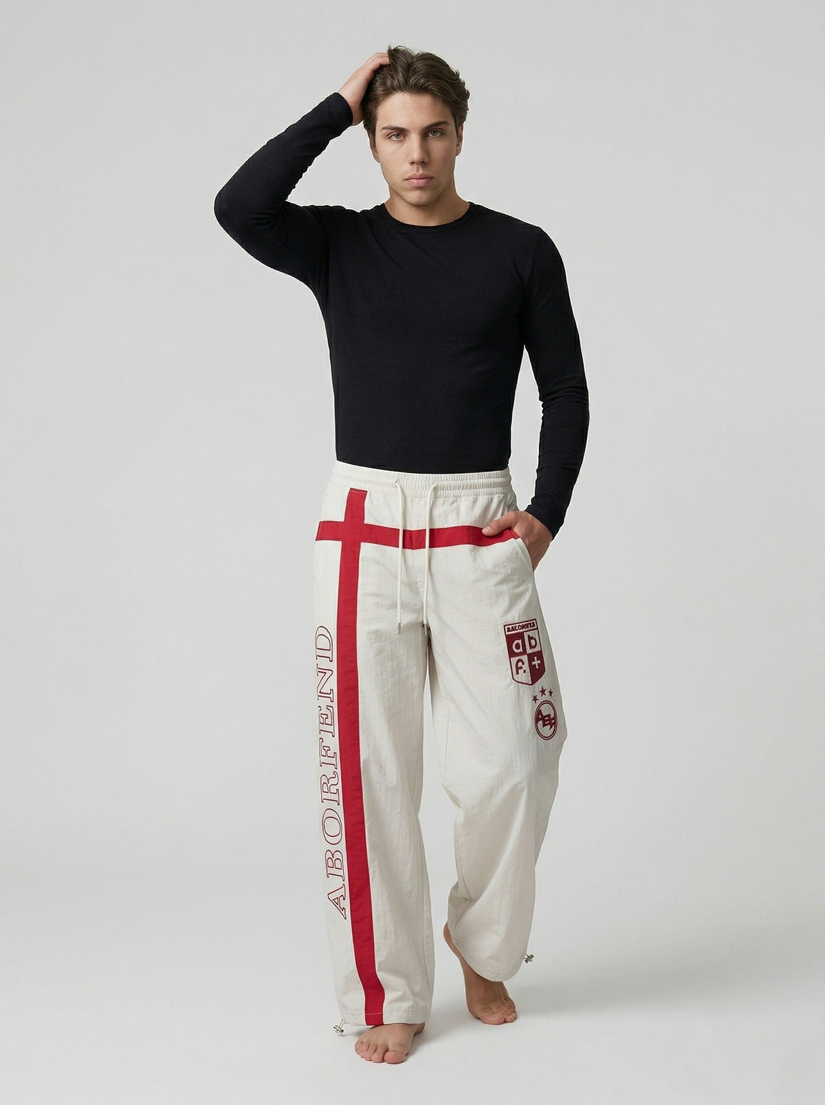 DAXUEN Wide-leg pants with red cross graphic and adjustable drawstrings — model photo