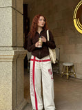 DAXUEN Wide-leg pants with red cross graphic and adjustable drawstrings — model photo