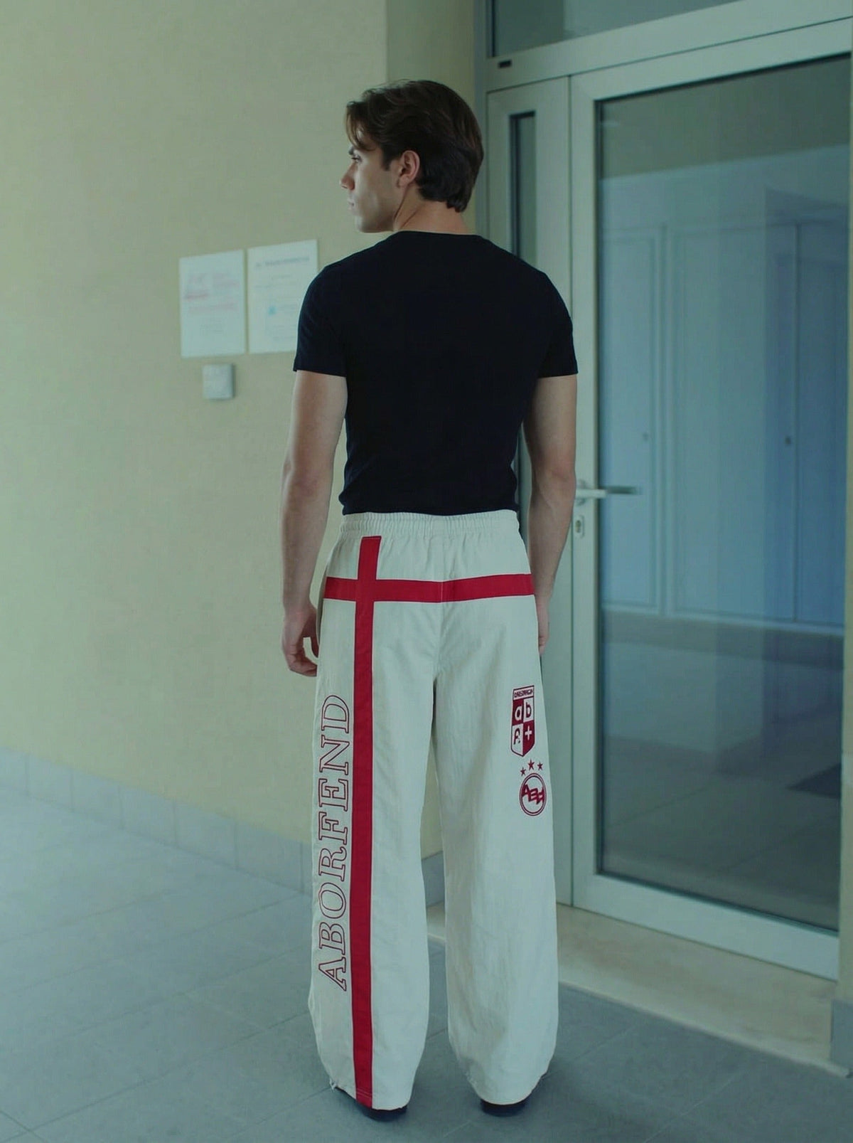 DAXUEN Wide-leg pants with red cross graphic and adjustable drawstrings — model photo