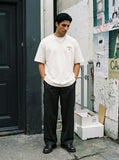 DAXUEN black oversized bold-emblem back print tee — model photo