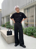 DAXUEN black oversized bold-emblem back print tee — model photo
