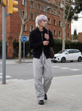 DAXUEN black wide-leg trousers with bold emblem — model photo