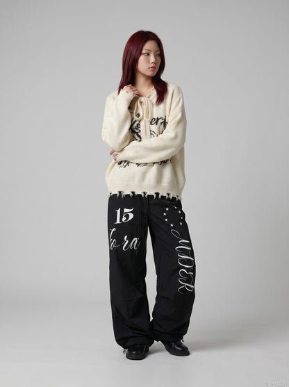 DAXUEN Oversized wide-leg track pants with graphic prints — model photo