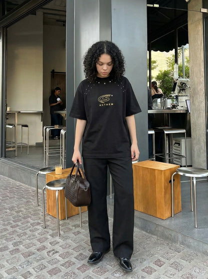 DAXUEN Bold oversized t-shirt with graphic embroidery and studs — model photo