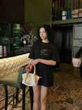 DAXUEN Bold oversized t-shirt with graphic embroidery and studs — model photo