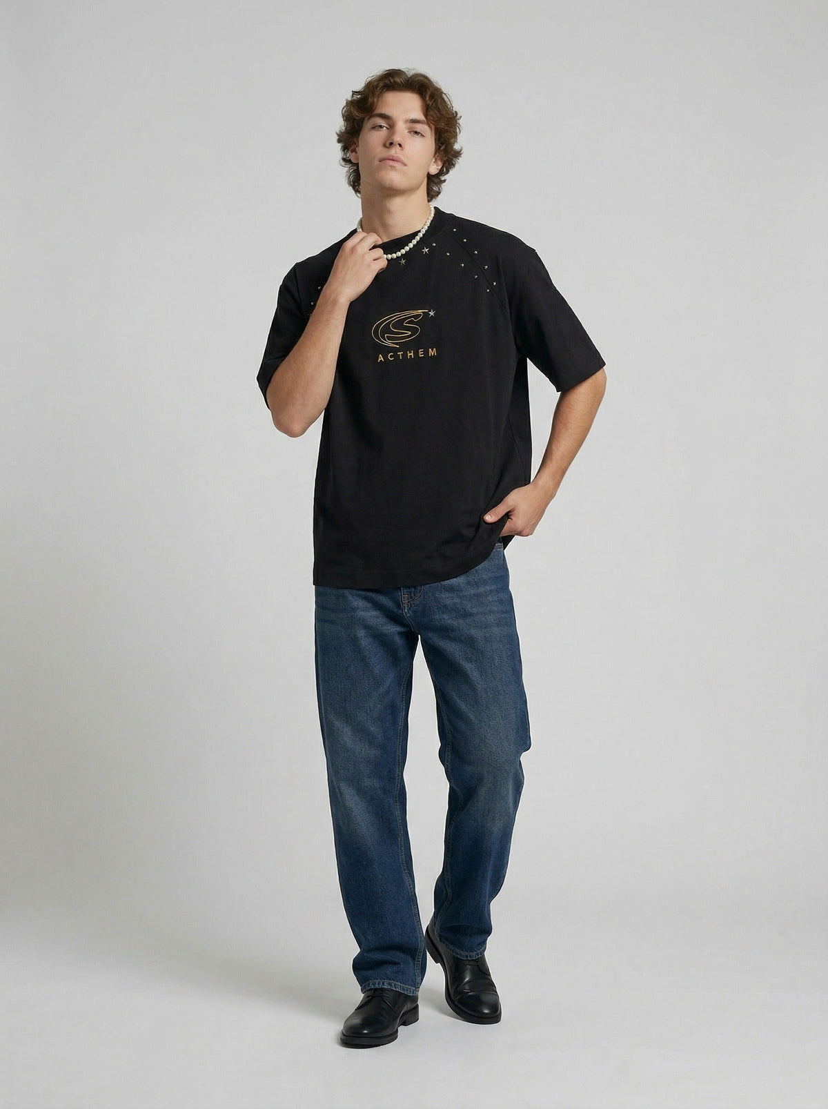 DAXUEN Bold oversized t-shirt with graphic embroidery and studs — model photo