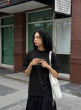DAXUEN Bold oversized t-shirt with graphic embroidery and studs — model photo