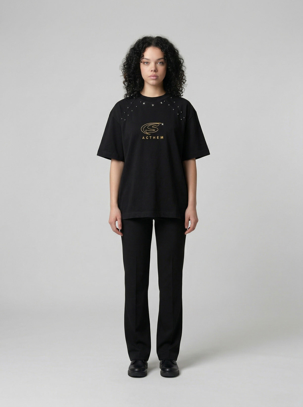 DAXUEN Bold oversized t-shirt with graphic embroidery and studs — model photo