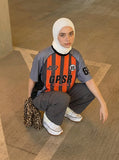 DAXUEN Multi-panel short-sleeved t-shirt in grey, black, and orange — model photo