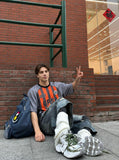 DAXUEN Multi-panel short-sleeved t-shirt in grey, black, and orange — model photo