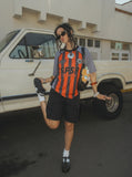 DAXUEN Multi-panel short-sleeved t-shirt in grey, black, and orange — model photo