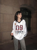 DAXUEN white oversized plaid '09' graphic v-neck jersey top — model photo