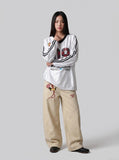 DAXUEN white oversized plaid '09' graphic v-neck jersey top — model photo