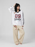 DAXUEN white oversized plaid '09' graphic v-neck jersey top — model photo