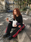 DAXUEN black oversized bold-red-side-panel sweatpants — model photo
