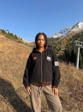 DAXUEN black oversized hooded jacket with red star patch — model photo
