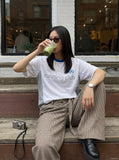 DAXUEN white athletic top with running club graphic — model photo