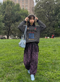 DAXUEN black oversized bold-script and distressed-denim polo shirt — model photo