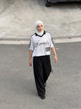 DAXUEN Short-sleeved polo shirt with vertical stripes and graphic text — model photo