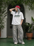 DAXUEN white oversized bold-stacked-text graphic tee — model photo