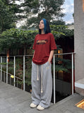 DAXUEN white oversized bold-stacked-text graphic tee — model photo