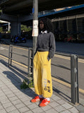 DAXUEN yellow and dark blue studded graphic wide-leg pants — model photo